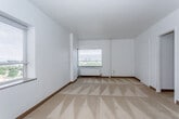 Located at 640 E Armour Blvd in Kansas City, Missouri, this single-floor unit offers a practical and straightforward layout across several functional spaces. The living area is generously sized, finished with wall-to-wall neutral carpeting and bright white walls that create a clean, open feel. Multiple windows allow natural light to filter in, offering views of the surrounding neighborhood streetscape.

The galley-style kitchen is well-appointed with rich wood-toned cabinetry lining both walls, providing ample upper and lower storage. It is equipped with a gas range, black refrigerator, and a double sink with counter space, all set atop light-toned flooring that complements the cabinetry. Open shelving at the kitchen entrance adds additional storage flexibility.

The bedroom is a spacious, carpeted room featuring a dedicated closet and direct access to the bathroom. A wall-mounted heating unit and a window with blinds complete the room. The full bathroom features classic white subway tile surrounding a soaking tub with shower, a pedestal-style sink, a wall mirror, and a window that introduces natural light into the space.

Overall, this unit presents a functional and comfortable living environment with classic finishes throughout, situated in an established Kansas City neighborhood.