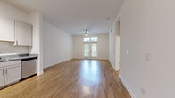 Located at 4520 Charlotte Park Dr in Charlotte, NC, this well-appointed one-bedroom, one-bathroom residence offers a thoughtfully designed single-floor layout. The open living room is a bright, welcoming space featuring warm hardwood-style flooring, a ceiling fan, and French doors that flood the room with natural light and provide outdoor views, creating an airy, comfortable atmosphere.

The kitchen is well-equipped with white shaker-style cabinetry, granite countertops, a classic subway tile backsplash, and a full suite of stainless steel appliances including a refrigerator, range, microwave, and dishwasher. Track lighting and hardwood-style floors complete the modern, clean aesthetic.

The bedroom is a comfortable retreat with plush carpeting, a large window offering outdoor views and ample natural light, and a ceiling fan for added comfort. A dedicated closet provides convenient storage.

The bathroom is finished with granite countertops, a white subway-tiled tub and shower surround, brushed nickel fixtures, and hardwood-style flooring, maintaining a cohesive, polished look throughout.

A dedicated in-unit laundry room houses a full-size washer and dryer with overhead wire shelving for additional storage. A hallway connects all areas of the home efficiently, rounding out this functional and modern Charlotte residence.