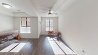 Located at 222 E Bland St in Charlotte, NC's vibrant South End neighborhood, this single-floor residence offers a thoughtfully designed layout with a clean, contemporary aesthetic throughout. Rich hardwood-style flooring flows seamlessly across the entire unit, anchoring each space with warmth and continuity.

The living area is bright and inviting, benefiting from multiple windows that usher in generous natural light and frame views of the surrounding neighborhood. A ceiling fan with a classic brass fixture adds both comfort and character to the space.

The kitchen is a standout feature, designed with efficiency and style in mind. Dark cabinetry contrasts sharply against light countertops and stainless steel appliances, including a refrigerator, range, microwave, and dishwasher. Open shelving provides display and storage space, while a moveable kitchen island adds flexible functionality. Track lighting overhead ensures the kitchen is well-illuminated throughout the day.

The bathroom is clean and functional, finished with a dark vanity, hardwood-style flooring, and tasteful fixtures. Directly accessible from the bathroom is a dedicated walk-in closet, complete with a full-length rod and shelving, offering practical and organized storage. The unit's single-level layout ensures easy navigation and a cohesive living experience.
