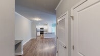 Located at 311 Lily Pad Ln in Sanford, NC, this well-appointed single-floor home offers three bedrooms, two bathrooms, and a thoughtfully designed layout. The kitchen is a standout feature, showcasing white shaker-style cabinetry, granite countertops, stainless steel appliances, a peninsula with a built-in sink, pendant lighting, and warm hardwood-style flooring that extends into the living area. Crown molding adds a refined touch to the open living space. The generously sized primary bedroom features soft carpeting, crown molding, and natural light, while the additional bedrooms each offer ceiling fans, plush carpet, and windows with views of lush greenery. The bathrooms are finished with tile flooring, granite-topped vanities with dark cabinetry, and a tub/shower combination with a curved curtain rod. A dedicated laundry room with built-in shelving and utility hookups adds everyday convenience. Outside, a fenced backyard backs up to a natural tree line, providing a peaceful, private setting. The exterior features a stone accent facade, enhancing the home's curb appeal. Overall, the space offers a clean, modern aesthetic with comfortable, functional living throughout.