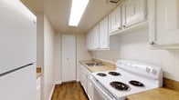 Located at 800 Cottman Avenue in the Fox Chase neighborhood of Philadelphia, Pennsylvania, this single-floor residence offers a practical and well-maintained living environment. The kitchen is a standout feature, designed with functionality in mind. It showcases crisp white cabinetry with raised-panel detailing, offering generous upper and lower storage, complemented by light-toned countertops. A stainless steel sink is seamlessly integrated into the layout, while a white electric coil-top range provides a full cooking setup. The kitchen also includes a dedicated pantry closet, adding valuable storage space. Warm hardwood-style flooring runs throughout, lending a clean and cohesive aesthetic to the space. Bright overhead lighting illuminates the kitchen efficiently, creating a well-lit workspace. The overall design prioritizes clean lines and a neutral color palette, giving the space a bright and airy feel. The single-floor layout ensures ease of navigation and accessibility throughout the residence. Situated along Cottman Avenue, the property benefits from convenient access to the surrounding amenities and transportation options characteristic of the Northeast Philadelphia area.