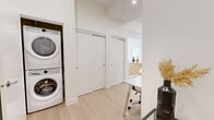 Located at 2826 Jacklin Rd in Victoria, BC, this thoughtfully designed two-bedroom, two-bathroom residence offers a clean, modern aesthetic throughout. Light hardwood flooring runs continuously across the single floor, complementing the crisp white walls and creating a bright, cohesive feel.

The open-concept living and dining area is bathed in natural light through large windows that frame scenic views of the neighbourhood and rolling hills beyond. A private balcony extends the living space outdoors. The kitchen is well-appointed with warm natural wood cabinetry, marble-look quartz countertops and backsplash, stainless steel appliances including a range and refrigerator, and a stainless range hood — a stylish and functional space for everyday cooking.

Both bedrooms are serene and light-filled, with large windows offering pleasant outdoor views. The primary bedroom benefits from generous closet space and direct access to a beautifully finished ensuite bathroom, featuring a floating double-sink vanity with quartz countertops, light wood cabinetry, and a large window overlooking the treetops. The second bathroom includes a soaker tub with a glass-enclosed marble-tiled surround and a matching floating vanity.

Additional highlights include in-suite stacked laundry and ample closet storage throughout, making this a highly functional and elegant residence.