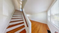 Located at 138 Grandview Ct in Ithaca, NY, this two-bedroom, one-bathroom home spans three floors, offering a well-distributed layout with a comfortable sense of space throughout. Warm hardwood flooring runs consistently across the main and upper levels, lending a cohesive and inviting character to the interior.

The main floor opens through a welcoming entrance into a bright living room, illuminated by multiple windows with views of the surrounding neighborhood. The kitchen is equipped with oak cabinetry, a gas range, a stainless steel sink with countertop workspace, and tile flooring, alongside a window that brings in natural light.

Upstairs, two bedrooms feature the same rich hardwood floors seen throughout the home. The primary bedroom benefits from corner windows on two walls, filling the room with natural light, while the second bedroom offers a quiet, clean layout. The full bathroom includes a soaking tub with shower, tile flooring, and a window for ventilation and light.

The basement level provides two utility areas, including a dedicated laundry space with a full-size washer and dryer, offering added convenience. Concrete stairs connect the basement to the upper floors. With its multi-level layout and practical amenities, this Ithaca home is a functional and comfortable residence.