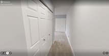 This 730 square foot apartment in Falls Church, Virginia, offers a well-designed living space on a single floor. The property features one bedroom and one bathroom, making it ideal for singles or couples. The primary bedroom is notably spacious at 220 square feet, providing ample room for relaxation and storage.

The kitchen is a standout feature, boasting modern stainless steel appliances including a refrigerator, oven with stovetop, microwave, and dishwasher. Rich wood cabinetry contrasts beautifully with the sleek appliances, while granite countertops add a touch of elegance. The backsplash and tile flooring complete the contemporary look.

The living areas are characterized by neutral tones, with light gray walls and plush carpeting creating a bright, airy ambiance. Recessed lighting throughout ensures even illumination. Large windows in the bedroom and living area allow natural light to flood the space, enhancing the sense of openness.

The bathroom, while compact, is efficiently designed with a granite-topped vanity matching the kitchen's aesthetic. A round mirror and modern lighting fixtures add style, while a closet provides additional storage.

The open-plan layout seamlessly connects the kitchen to the living area, ideal for entertaining. Overall, this apartment combines modern amenities with a practical layout, offering comfortable living in a prime Falls Church location.
