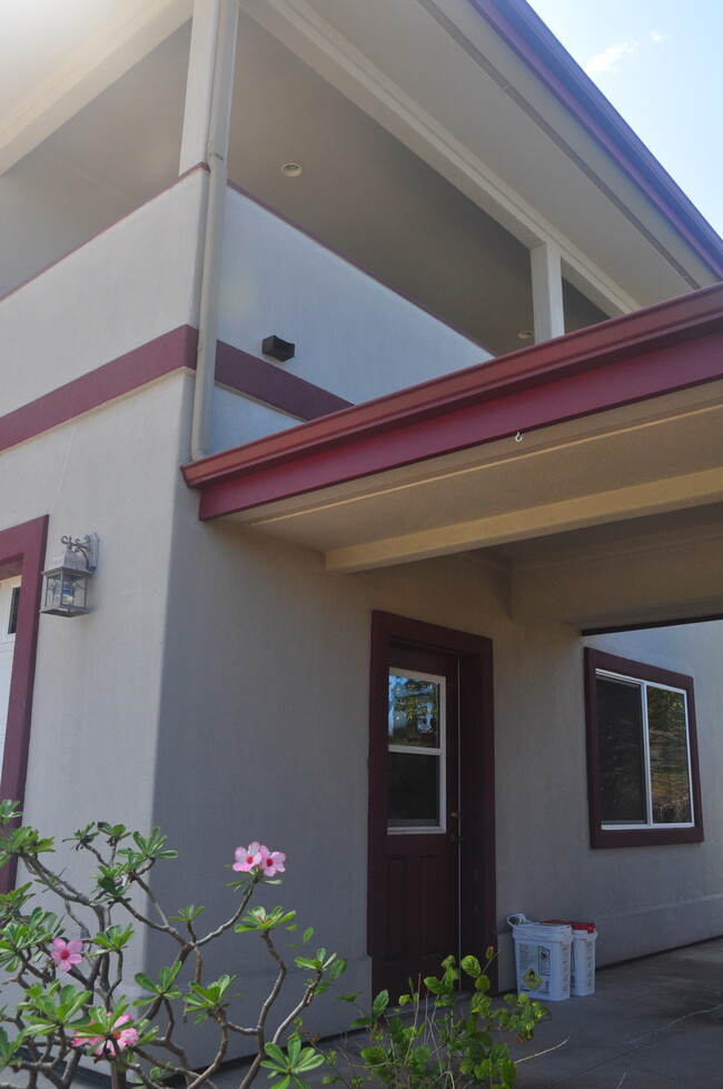 Entryway to garage with automatic garage door opener - 75-6139 Akoa St