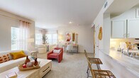 This thoughtfully designed one-bedroom, two-bathroom residence in Independence, Missouri offers a comfortable and functional single-floor layout. The bright living room serves as the heart of the home, featuring plush carpet, multiple windows that invite abundant natural light, and a sleek linear electric fireplace set into the wall — ideal for relaxing evenings. The space flows seamlessly into a well-defined dining area, completing a welcoming open-concept feel.

The kitchen is outfitted with white shaker-style cabinetry, marble-look countertops, a classic subway tile backsplash, and stainless steel appliances including a range, microwave, and refrigerator. A skylight adds extra brightness, while tile flooring and ample counter space enhance both form and function.

The generously sized primary bedroom features soft carpet, a ceiling fan, and multiple windows offering natural light and outdoor views. Both bathrooms are finished with white cabinetry, marble-look countertops, and clean tile work — one including a tub/shower combination.

A utility area with built-in shelving and electrical panel access provides practical storage. Throughout, the residence maintains a warm, neutral palette with consistent finishes, creating a cohesive and inviting atmosphere.
