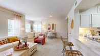 This thoughtfully designed one-bedroom, two-bathroom residence in Independence, Missouri offers a comfortable and functional single-floor layout. The bright living room serves as the heart of the home, featuring plush carpet, multiple windows that invite abundant natural light, and a sleek linear electric fireplace set into the wall — ideal for relaxing evenings. The space flows seamlessly into a well-defined dining area, completing a welcoming open-concept feel.

The kitchen is outfitted with white shaker-style cabinetry, marble-look countertops, a classic subway tile backsplash, and stainless steel appliances including a range, microwave, and refrigerator. A skylight adds extra brightness, while tile flooring and ample counter space enhance both form and function.

The generously sized primary bedroom features soft carpet, a ceiling fan, and multiple windows offering natural light and outdoor views. Both bathrooms are finished with white cabinetry, marble-look countertops, and clean tile work — one including a tub/shower combination.

A utility area with built-in shelving and electrical panel access provides practical storage. Throughout, the residence maintains a warm, neutral palette with consistent finishes, creating a cohesive and inviting atmosphere.