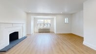 Located at 1216 Avenue Rd in Toronto's desirable Avenue Road corridor, this well-appointed 2-bedroom, 1-bathroom unit offers a thoughtfully designed single-floor layout with a generous total footprint. Throughout the unit, light-toned hardwood flooring and crisp white walls create a clean, modern aesthetic.

The main living room is a standout space, featuring vaulted ceilings, recessed pot lights, a wall-mounted mini-split system, a classic white decorative fireplace, and a large window framing views of mature neighbourhood trees. A secondary living area provides additional flexible space, complete with built-in upper cabinetry and light wood finishes — ideal for a dining area or home office.

The kitchen is efficiently laid out with white shaker-style lower cabinets, light wood upper cabinetry, stainless steel appliances including a refrigerator, range, and over-the-range microwave, and a window above the sink for natural light. A dedicated laundry room houses a full-size front-loading washer and dryer.

The spacious primary bedroom features a traditional radiator, a wall-mounted mini-split, and a window with outdoor views. The second bedroom is equally bright and well-proportioned. The bathroom includes a soaker tub, large-format tile surround, and a privacy window. A private balcony rounds out the unit, offering open views of the surrounding neighbourhood.