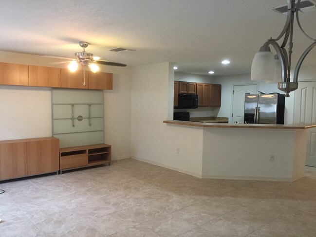 Wall-mounted entertainment center included. - 11634 Mango Ridge Blvd