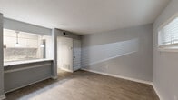 Located at 510 Broadway in Columbus, GA, this efficient single-floor unit offers a thoughtfully arranged layout encompassing a living room, bedroom, and full bathroom. The living area is bright and welcoming, featuring light wood-style flooring, soft gray walls, and a wide horizontal window that allows natural light to fill the space. A front entry door leads directly into this open area, creating a straightforward and functional flow throughout.

The kitchen is positioned adjacent to the living space and features white cabinetry, granite-style countertops, a stainless steel range, and a pendant light fixture overhead — providing a clean, modern aesthetic. A pass-through counter connects the kitchen to the living area, enhancing the open feel.

The bedroom offers comfortable carpeted flooring, a ceiling fan with light, and a window with views of surrounding greenery. Ample storage is provided by a set of sliding-door closets, along with an additional open closet, making organization easy.

The bathroom is finished with tile-style flooring, a vanity with stone-look countertops, and a full tub/shower combination with a crisp white surround. The clean, neutral palette found throughout the unit creates a cohesive and move-in-ready atmosphere ideal for those seeking practical, modern living in Columbus, GA.
