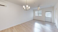 Located at 32015 Azure Ave in Rehoboth Beach, Delaware, this single-floor, three-bedroom, two-bathroom residence offers a clean, modern layout designed for comfortable living. Light wood-style flooring runs throughout the main living areas, while plush carpet adds warmth to each bedroom.

The kitchen is a standout feature, showcasing dark shaker-style cabinetry, white quartz countertops, a tiled herringbone backsplash, and a full suite of stainless steel appliances including a range, microwave, and refrigerator. A peninsula with an undermount sink and pendant lighting above connects the kitchen to the dining area, creating an open and functional space ideal for entertaining.

The primary bedroom includes direct access to an en-suite bathroom and is serviced by a wall-mounted mini-split unit for climate control. The en-suite features dark wood vanity cabinetry and a glass-enclosed walk-in shower with subway tile surround. Additional bedrooms are bright and well-proportioned, one featuring a double-door closet. A dedicated walk-in closet and a separate laundry room with a full-size washer and dryer add to the home's practicality. A hallway with built-in wall hooks provides convenient entry storage, completing this well-appointed residence.