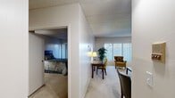 Located at 15075 Lincoln St in Oak Park, Michigan, this one-bedroom, one-bathroom residence offers a practical and comfortable single-floor layout. The living room is a welcoming space featuring plush carpeting, a textured ceiling, and a large window fitted with vertical blinds that invite natural light while providing privacy. The room comfortably accommodates a seating arrangement and a small work area, making it both a relaxing and functional space.

The kitchen is equipped with warm-toned wood cabinetry, ample counter space, a built-in dishwasher, and a range, all set atop classic parquet-style flooring. The layout is efficient and well-organized for everyday cooking and meal prep.

The bedroom is a generously proportioned retreat with soft carpeting, a closet, and a window that brings in natural light. Neutral walls create a calm, restful atmosphere throughout.

The bathroom features a single-sink vanity with storage cabinetry, a large mirror with overhead lighting, and a full tub-shower combination with tiled surround.

A hallway connects the rooms seamlessly, and an additional closet provides practical storage. Overall, the space offers a cohesive, comfortable living environment with consistent neutral tones and carpet throughout.