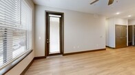 Located at 871 Oak Meadow Dr in Franklin, TN, this well-appointed 2-bedroom, 2-bathroom residence offers a thoughtfully designed single-floor layout. The open-concept living area seamlessly connects the kitchen, dining, and living spaces, all finished with light wood-tone flooring and neutral tones that create a bright, welcoming atmosphere. Large windows allow natural light to pour in throughout, complemented by ceiling fans in key rooms.

The kitchen is a standout feature, showcasing white shaker cabinetry extending to the ceiling, a quartz-topped center island with a stainless steel sink, pendant lighting with globe fixtures, and a full suite of stainless steel appliances including a refrigerator, range, microwave, and dishwasher. Track lighting adds additional illumination over the workspace.

The primary bedroom offers generous proportions with large windows and an en-suite bathroom featuring a quartz vanity, dual mirrors, tile flooring, and a glass-enclosed walk-in shower. The second bedroom is carpeted and equally well-lit. The secondary bathroom includes a full tub-shower combo and a white vanity with ample storage. Additional highlights include three closets, a dedicated laundry area, and a hallway connecting all spaces efficiently.