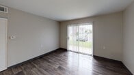 Located at 19 Willow Creek Dr in Battle Creek, Michigan, this single-floor unit offers a well-designed, open-concept layout with functional living spaces and modern finishes throughout. The kitchen is a standout feature, equipped with dark espresso cabinetry, a gas range, black appliances including a full-size refrigerator, a double-basin stainless steel sink, and light-toned countertops. A peninsula counter opens directly to the living area, creating a seamless flow between spaces. The living area features durable wood-style flooring, neutral wall tones, and a sliding glass door that invites abundant natural light and provides direct outdoor access. The bedrooms are carpeted for comfort and each includes a window with blinds, providing natural light and a quiet, restful atmosphere. Two bathrooms serve the unit — one full bath complete with a soaking tub, shower, vanity with stone-look countertop, and wood-style flooring, and a second bathroom featuring a toilet and vanity. Throughout the unit, consistent dark baseboards and neutral paint tones create a cohesive, clean aesthetic. The single-floor design ensures easy accessibility and a practical, connected living experience.