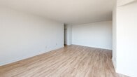 This 2-bedroom, 1-bathroom unit at 1350 Danforth Road in Toronto offers a clean, modern aesthetic throughout, characterized by white walls, light-toned hardwood-style flooring, and an abundance of natural light. The open-concept living and kitchen area forms the heart of the unit. The living room is generously proportioned, featuring large sliding glass doors that lead to a balcony with open city views, allowing sunlight to flood the space throughout the day.

The kitchen is well-appointed with white shaker-style cabinetry, dark countertops, a white subway tile backsplash, and a full suite of stainless steel appliances, including a refrigerator, dishwasher, electric range, and built-in microwave.

Both bedrooms feature the same light flooring and white walls, with windows offering elevated city views and baseboard heating units. The primary bedroom provides a comfortable and well-lit retreat. The second bedroom is equally bright and versatile.

The bathroom is finished with white subway tile surrounding a full soaker tub and shower combination, paired with clean, simple fixtures. A hallway connects the rooms, providing a practical layout throughout this well-maintained, light-filled unit.