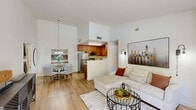 Located on Calle Albara in El Cajon, CA, this single-floor, 2-bedroom, 2-bathroom home offers a thoughtfully designed layout with comfortable living spaces and modern finishes throughout. The open-concept living room serves as the heart of the home, showcasing light hardwood-style flooring, a tile-framed fireplace, and a sliding glass door that opens to a private patio with outdoor views of lush greenery — filling the space with abundant natural light. The kitchen is efficiently designed with warm wood cabinetry, granite countertops, stainless steel appliances, and a peninsula that opens toward the dining area, making it ideal for both cooking and entertaining. The spacious primary bedroom features plush carpeting, a large window with outdoor views, and direct access to its own en-suite bathroom. The en-suite bathroom is finished with granite countertops and a tiled shower. The second bedroom is equally well-sized with soft carpeting and bright windows, complemented by a second full bathroom featuring a tiled tub-shower combination with a built-in niche. Hallways connect the rooms with ease, and a dedicated closet provides additional storage. The overall ambiance is clean, modern, and inviting, with a neutral color palette that enhances the sense of openness throughout.