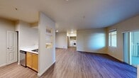 This 580 square foot apartment in Mill Creek, WA, offers a thoughtfully designed living space that maximizes efficiency and comfort. The open-concept layout seamlessly integrates the kitchen, living room, and dining area, creating a sense of spaciousness. The kitchen boasts light wood cabinetry, stainless steel appliances, and ample counter space with white surfaces.

The living area is highlighted by a cozy gas fireplace and sliding glass doors that lead to a balcony, allowing natural light to flood the space. Hardwood-style flooring runs throughout the apartment, adding warmth and continuity. The bedroom, measuring 140 square feet, features a large window that provides a view of the surrounding greenery.

The bathroom is equipped with a full-sized tub/shower combination, a single vanity, and additional storage. The apartment's design incorporates clever storage solutions, including built-in shelving and closet space. Track lighting in the kitchen and recessed lighting in other areas provide adjustable illumination options.

This single-floor dwelling offers a perfect blend of modern amenities and efficient living, ideal for those seeking a low-maintenance lifestyle in a prime location. The neutral color palette and clean lines contribute to a contemporary aesthetic that can easily accommodate various decor styles.