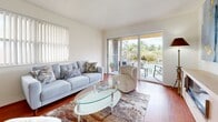 This 710 square foot apartment in Pembroke Pines, Florida, offers a well-designed living space with one bedroom and one bathroom. The open-concept floor plan seamlessly integrates the living room, dining area, and kitchen, maximizing the use of space. The living room features warm hardwood flooring, a comfortable grey sofa, and sliding glass doors that lead to a balcony with views of palm trees, bringing the Florida landscape indoors.

The kitchen boasts light wood cabinetry, stainless steel appliances, and a clean white backsplash, creating a bright and functional cooking space. The dining area, adjacent to the kitchen, features a modern white table with seating for six, perfect for entertaining or family meals.

The bedroom, measuring 150 square feet, offers a serene retreat with plush carpeting, a large window for natural light, and ample space for a queen-sized bed and additional furniture. The bathroom, while compact, is efficiently designed with a combination tub and shower, and a large mirror to enhance the sense of space.

Throughout the apartment, a neutral color palette with pops of blue in artwork and accessories creates a cohesive and calming atmosphere. The property's single floor layout and modern amenities make it an ideal home for individuals or couples seeking a comfortable living space in the heart of Pembroke Pines.