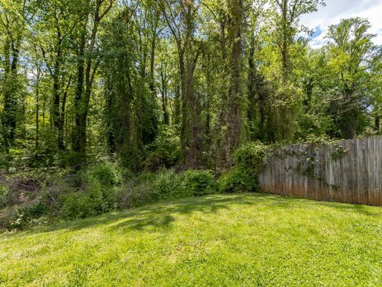 Secluded back yard backing to a creek. - 610 Rock Creek Road