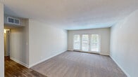 Located at 2041 Shady Grove Way in Louisville, Kentucky, this single-story, 3-bedroom, 2-bathroom home offers a functional and well-organized layout. The living room is a comfortable, carpeted space highlighted by a set of French doors that invite natural light and provide access to an outdoor area. A separate dining room complements the updated kitchen, which features white shaker-style cabinetry, granite-look countertops, wood-look flooring, and stainless steel appliances including a dishwasher and electric range. All three bedrooms are carpeted and finished in neutral tones, providing a clean and versatile canvas. The spacious primary bedroom offers ample room for furnishings. Both bathrooms include tub/shower combinations with marble-style surround panels and wood-look flooring for a polished finish. A dedicated laundry room with washer and dryer hookups adds practical convenience. Four closets are distributed throughout the home, ensuring generous storage. A connecting hallway ties the layout together efficiently. The overall palette of soft neutrals, consistent flooring choices, and textured ceilings gives the home a cohesive, move-in-ready feel throughout.