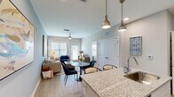 Located at 7600 Heron Cir in Vero Beach, Florida, this thoughtfully designed 2-bedroom, 1-bathroom residence offers a comfortable and modern living experience across a single floor. The open-concept kitchen and living area serves as the heart of the home, where the kitchen impresses with crisp white shaker cabinetry, granite countertops, a classic subway tile backsplash, stainless steel appliances, and a central island with pendant lighting — ideal for both cooking and entertaining. Light wood-style flooring flows throughout the main living areas, adding warmth and continuity. The living room is bright and welcoming, featuring large windows that allow abundant natural light, a ceiling fan, and direct access to the outdoors. Both bedrooms are carpeted for comfort and feature ceiling fans, generous windows, and tasteful accent walls in soothing coastal tones. The primary bedroom offers a comfortable, well-proportioned retreat. The bathroom is finished with granite countertops, white cabinetry, a large vanity mirror, and wood-style flooring, with a dedicated walk-in closet providing excellent storage. A connecting hallway with additional closet space enhances the home's functional layout. Neutral, contemporary color palettes and consistent quality finishes throughout give this residence a polished, cohesive feel.