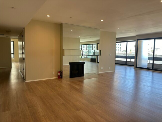 Large living room with fireplace and views - 10551 Wilshire Blvd