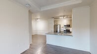 Located at 6451 Tranquilo in Irving, TX, this well-appointed one-bedroom, one-bathroom residence offers a thoughtfully designed single-floor layout. The open-concept living area seamlessly connects the living room, dining room, and kitchen, all finished with durable hardwood-style flooring throughout. Crown molding adds a refined touch to the main living spaces.

The kitchen is a standout feature, centered around a granite-topped peninsula with an undermount stainless steel sink and a sleek coil-style faucet. Cream cabinetry provides ample storage, while stainless steel appliances — including a French door refrigerator, electric range, and microwave — complete the space. A pantry offers additional storage convenience.

The living room boasts a tray ceiling with crown molding and a ceiling fan, and French doors open directly onto a private balcony, allowing for natural light and outdoor access. The spacious bedroom features its own ceiling fan, a large window with outdoor views, and direct access to a generous walk-in closet with multi-tier wire shelving.

The bathroom includes a granite-topped vanity with undermount sink, sage-toned cabinetry, and hardwood-style flooring. A dedicated laundry room houses a full-size side-by-side washer and dryer, complemented by overhead wire shelving for added utility.