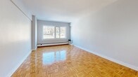 Located at 1400 Avenue des Pins Ouest in Montréal, this well-appointed one-bedroom, one-bathroom unit offers a thoughtfully designed layout across a single floor. Gleaming parquet wood flooring runs throughout the main living areas, adding warmth and character to the space.

The open combined dining and living room is generously proportioned, bathed in natural light through large windows that overlook the surrounding neighbourhood. The area provides ample room for both lounging and dining, with a clean, neutral palette that complements a variety of décor styles.

The kitchen is notably well-equipped, featuring stainless steel appliances including a refrigerator, stove, and dishwasher. A mosaic tile backsplash accents the two-toned cabinetry — white lower cabinets paired with rich wood-grain upper cabinets — set against dark countertops and light tile flooring.

The spacious primary bedroom accommodates a full suite of furniture comfortably, with parquet floors continuing throughout and access to closet storage. The bathroom is finished with modern wood-look tile and large-format white wall tiles surrounding a full soaker tub with overhead shower.

Additional features include three closets for ample storage, a hallway, a dedicated entrance, and a private balcony. The unit offers a functional and stylish urban living experience in the heart of Montréal.