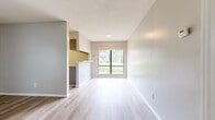 Located at 6619 Yateswood Dr in Charlotte, NC, this one-bedroom, two-bathroom residence offers a thoughtfully organized single-floor layout designed for comfortable everyday living. The living area features light-toned luxury vinyl plank flooring, neutral gray walls, and clean white trim throughout, creating a bright and cohesive aesthetic. A large sliding glass door opens to a private patio, allowing natural light to fill the space and providing a pleasant outdoor view. A secondary window in the living area further enhances the airy feel of the room.

The kitchen is positioned adjacent to the living space and is equipped with a full suite of white appliances, including an electric range, refrigerator, and dishwasher, complemented by gray cabinetry and ample counter space. A breakfast bar provides a convenient transition between the kitchen and living areas.

The bedroom is a generously sized, well-proportioned room featuring plush carpeting, soft neutral walls, and a window that invites natural light. A dedicated closet provides practical storage. The two bathrooms feature LVP flooring, vanities with under-cabinet storage, and clean, neutral finishes. A textured ceiling is present throughout, adding a classic architectural detail to the overall design of this well-maintained Charlotte residence.