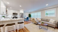 This thoughtfully designed one-bedroom residence at 70 Polifly Rd offers a functional and stylish single-floor layout. The open-concept kitchen and living area serves as the heart of the unit, where warm hardwood floors, recessed lighting, and crown molding create a polished, cohesive aesthetic. The kitchen is appointed with crisp white shaker cabinetry, granite countertops, a glossy subway tile backseat, open wood shelving, and a full suite of stainless steel appliances, including a dishwasher, range, and refrigerator. A peninsula with seating provides a casual dining option while maintaining the open flow into the living area. The living room benefits from multiple windows dressed with horizontal blinds, allowing ample natural light to fill the space with a bright, airy ambiance. The bedroom is a serene retreat, featuring neutral tones, hardwood flooring, crown molding, a window with natural light, and a dedicated closet for storage. Throughout the unit, the consistent use of warm wood floors, neutral paint tones, and clean architectural details gives the space a cohesive, move-in-ready character that balances comfort with modern style.