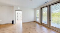 Located in Asheville, NC, this well-appointed 2-bedroom, 2-bathroom residence offers a thoughtfully designed single-level layout with modern finishes throughout. Light hardwood-style flooring flows seamlessly across the entire space, creating a warm and cohesive aesthetic.

The open-concept kitchen and living area serves as the heart of the home. The kitchen is outfitted with white shaker cabinetry, a subway tile backsplash, stainless steel appliances, and a large central island topped with quartz countertops — ideal for both meal preparation and casual dining. Pendant lighting adds a polished finishing touch.

Both bedrooms are bright and airy, featuring large windows and sliding glass doors that invite generous natural light. The primary bedroom includes direct balcony access, a ceiling fan, and a private en suite bathroom with a glass-enclosed shower, quartz vanity, and a walk-in closet. The second bathroom offers a full tub-shower combo with large-format tile surround and matte black fixtures.

A standout feature of this residence is the expansive balcony, which offers sweeping views of a serene lake framed by lush tree canopy — a truly picturesque outdoor retreat. The overall ambiance is clean, contemporary, and move-in ready, making it an exceptional offering in the Asheville area.