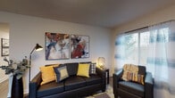 Located at 115 Carriage Hill Dr in Athens, Ohio, this single-floor residence offers a well-organized layout designed for comfortable everyday living. The living room serves as the heart of the home, featuring wood-look flooring, neutral walls, and natural light streaming through windows dressed with sheer striped curtains and blinds. The space accommodates a full seating arrangement and includes wall-mounted artwork, decorative shelving, and a media console, creating an inviting and functional atmosphere.

The kitchen is laid out in a galley configuration, with warm honey-toned cabinetry lining both sides, granite-patterned countertops, a double sink, and standard appliances including a range and refrigerator. Ample cabinet storage makes the kitchen both practical and efficient.

The two bedrooms are each well-proportioned, with wood-look flooring, windows providing natural light, and enough space to accommodate a full bed, desk, and storage. One bedroom features dark curtains and a dedicated study area, while the second offers a colorful, personalized aesthetic with patterned curtains and wall art.

The bathroom is appointed with rich wood-toned cabinetry, a large vanity mirror, built-in tall storage cabinet, and a shower/tub combination, offering ample storage and functionality.