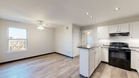 Located in Oklahoma City, OK, this well-designed one-bedroom, one-bathroom residence offers a thoughtful layout that maximizes every inch of its compact footprint. The open-concept living and kitchen area forms the heart of the unit, where wood-look luxury vinyl flooring flows seamlessly throughout. The kitchen is a functional highlight, featuring white shaker-style cabinetry, dark granite-style countertops, a peninsula island with additional storage and prep space, recessed lighting, a black gas range, a refrigerator, and a sink with dishwasher. A ceiling fan with light kit overhead keeps the adjacent living area comfortable and well-lit. The spacious bedroom offers a ceiling fan, a closet, natural light through a window with outdoor views, and direct access to the full bathroom. The bathroom is clean and classic, equipped with a full-size soaking tub and shower combination with built-in shelving, chrome fixtures, and a vanity with storage. The unit maintains a neutral, modern color palette of soft grays and whites throughout, creating a bright and cohesive atmosphere. This single-floor residence delivers practical, move-in-ready living in a clean, contemporary style.