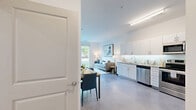 Located at 4225 Innslake Dr in Glen Allen, VA, this one-bedroom, one-bathroom residence offers a thoughtfully designed open-concept layout that seamlessly connects the kitchen, dining, and living areas into one cohesive, light-filled space. The kitchen is well-appointed with crisp white cabinetry, granite countertops, a subway tile backsplash, stainless steel appliances including a refrigerator, range, microwave, and dishwasher, and polished concrete flooring that extends throughout the main living area. The living room benefits from a large sliding glass door that frames lush outdoor greenery, allowing abundant natural light to fill the space. The bedroom is a comfortable and private retreat, featuring a window with outdoor views, a ceiling fan, and access to two closets for generous storage. The full bathroom is finished with large-format tile flooring and includes a tub-shower combination. Clean white walls, modern lighting, and a consistent neutral palette give the entire residence a bright, contemporary ambiance. The efficient single-floor layout maximizes every square foot, making this a well-organized and stylish home in the Glen Allen area.