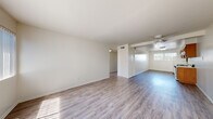 Located at 1206 W Fourth St in Ontario, California, this single-story residence offers a clean, functional layout designed for comfortable everyday living. The main living and dining areas are finished with light-toned wood-look luxury vinyl flooring that extends throughout, creating a cohesive and easy-to-maintain surface. A ceiling fan overhead adds to the practicality of the space, while windows allow natural light to fill the open floor plan. The kitchen is equipped with warm honey-toned wood cabinetry, light speckled countertops, a double stainless steel sink, a gas range, and a dishwasher, providing ample storage and workspace. The bedrooms feature soft wall-to-wall carpeting, generous closet space with sliding doors, and windows that bring in natural daylight. The bathroom is outfitted with a full tub and shower combination, complemented by wood-tone vanity cabinetry and a well-lit mirror above. Throughout the home, the neutral white walls and clean finishes create a bright, move-in-ready atmosphere. The straightforward single-floor layout ensures easy navigation between all areas of the home, making it a practical and welcoming space.