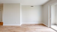Located at 601 NW 82nd Ave in Fort Lauderdale, FL, this well-designed one-bedroom, one-bathroom unit offers a clean, modern aesthetic throughout. Light wood-tone flooring flows seamlessly across the entire space, complemented by crisp white walls and white baseboards that create a bright, cohesive atmosphere.

The open-concept kitchen and living area serves as the heart of the unit. The kitchen is outfitted with sleek, flat-front white cabinetry, a white quartz island, and a full suite of stainless steel appliances including a refrigerator with ice maker, electric range, over-the-range microwave, and dishwasher. Track lighting illuminates the workspace, and a built-in closet near the entry provides convenient storage.

The living area opens directly onto a private balcony through sliding glass doors, offering pleasant tree-lined views and abundant natural light. A ceiling fan adds comfort to this airy space.

The bedroom is a well-proportioned retreat featuring a window with blinds that allows natural light to filter in. A dedicated closet is accessible from the hallway connecting the bedroom to the rest of the unit.

The bathroom features a soaking tub with a tiled surround in warm neutral tones, a toilet, and a vanity, all finished with wood-look flooring that ties the space together.