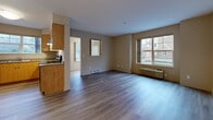 Located at 1588 Spall Rd in Kelowna, BC, this well-appointed 2-bedroom, 2-bathroom unit is thoughtfully laid out across a single floor. Light-toned laminate flooring runs throughout, lending a cohesive and clean aesthetic to every room.

The open-concept living, dining, and kitchen area forms the heart of the unit. The kitchen is equipped with warm wood cabinetry, granite-style countertops, a double stainless steel sink, and stainless steel appliances, including a refrigerator and range. A pendant light fixture adds a finishing touch above the dining area, while natural light filters in through the windows.

The primary bedroom is a generously sized retreat featuring a large window that brings in outdoor views and natural light. A second bedroom offers comfortable proportions with its own closet and easy access to the hallway. Both rooms feature the same neutral laminate flooring and warm wall tones found throughout the unit.

The two bathrooms are well-finished, with the primary bathroom offering a walk-in glass shower, a vanity with a stone-style countertop, and chrome fixtures. A second full bathroom provides additional convenience. The unit also includes dedicated laundry space and multiple closets for ample storage. A central hallway connects all rooms efficiently, completing this functional and comfortable layout.