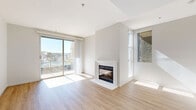 Located at 13970 Panay Way in Marina del Rey, this one-bedroom, one-bathroom residence offers a well-designed layout with marina views and an abundance of natural light throughout. The combined kitchen and living area serves as the heart of the home, featuring light wood-style flooring, crisp white walls, and a clean-lined fireplace as a focal point. Sliding glass doors open directly onto a private balcony overlooking the marina, where sailboats and calm waterway views create a quintessential Southern California backdrop. The kitchen is efficiently arranged with warm wood cabinetry, white appliances including a gas range, dishwasher, and refrigerator, and ample counter and storage space. The spacious bedroom is carpeted and bathed in natural light, with mirrored sliding closet doors that enhance the sense of space. A second set of sliding glass doors in the bedroom also provides balcony access and additional marina views. The bathroom features light wood-toned cabinetry, a white vanity with an integrated sink, a large mirror, and wood-style flooring. A dedicated closet rounds out the layout. The overall ambiance is bright, clean, and coastal, with a neutral palette that complements the sunny Marina del Rey setting.