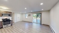 Located at 9951 Academy Rd in Philadelphia, PA, this well-appointed one-bedroom, one-bathroom unit offers a thoughtfully designed layout across a single floor. The open-concept living and kitchen area is anchored by light gray wood-look flooring, recessed lighting, and a sliding glass door that fills the space with natural light and provides outdoor access. Baseboard heating runs throughout, complemented by wall-mounted air conditioning units for year-round comfort.

The kitchen is a standout feature, outfitted with rich dark-toned cabinetry, light quartz countertops, a white subway tile backsplash, and a full suite of stainless steel appliances including a gas range, built-in microwave, dishwasher, and French door refrigerator.

The generously sized bedroom is carpeted for warmth and comfort, featuring two windows with natural light, a wall-mounted AC unit, and double closet doors offering ample storage. A stacked washer and dryer unit is conveniently integrated into the bedroom area. The bathroom features large-format tile flooring, a tub/shower combo with crisp white tile surround, and a decorative mosaic accent border, completing this clean and functional space.