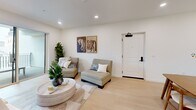 Located in Los Angeles' vibrant Koreatown neighborhood, this well-appointed 4-bedroom, 2-bathroom single-story home offers a thoughtfully designed layout with modern finishes throughout. The open-concept kitchen and living area serves as the heart of the home, featuring sleek two-tone cabinetry with warm wood lower cabinets and light gray uppers, white quartz countertops, stainless steel appliances including a side-by-side refrigerator, range, microwave, and dishwasher, all set against light hardwood flooring. The bright living room provides a welcoming atmosphere with recessed lighting and a clean, neutral palette. The generously sized primary bedroom is a standout feature, offering ample space, large windows that invite natural light, and access to two well-sized walk-in closets with built-in shelving and hanging rods. Three additional bedrooms provide flexible living options, with carpeted and hard flooring options. Both bathrooms are finished with light wood vanities, white countertops, and full bathtub-shower combinations. A private balcony and a connecting hallway complete the functional floor plan. The home's consistent use of light tones and modern materials creates a cohesive, contemporary ambiance throughout.