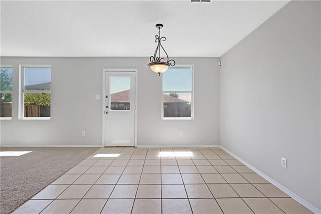 Eat-in dining and back door. Woodgrain tile not pictured. - 1419 Windy Meadows Dr