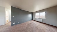 Located at 2207 Florida Dr in Fort Wayne, Indiana, this unit offers four bedrooms, one bathroom, and a kitchen across a single floor. The layout is practical and straightforward, making efficient use of the available space.

The spacious primary bedroom features bold slate-gray accent walls, plush carpeting, and a large window that allows natural light to fill the room. A wall-mounted heating unit ensures year-round comfort. The additional bedrooms are finished in neutral tones with carpet flooring, natural light from windows, and individual closet access — notably, the unit includes an impressive seven closets in total, providing exceptional storage throughout.

The kitchen is equipped with white cabinetry, a double stainless steel sink, light countertops, and a window overlooking the surroundings. Wood-style flooring grounds the space and adds a practical, easy-to-maintain surface.

The bathroom features wood-style flooring, a full bathtub with shower, a white vanity with under-sink storage, a mirrored medicine cabinet, and a window for ventilation. Clean white tile accents and bright lighting complete the functional design.

Overall, the unit presents a clean, no-frills interior with ample bedroom space, generous storage, and essential amenities suited for comfortable everyday living in Fort Wayne.