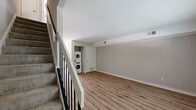 Located at 406 Lingstorm Ln in North Chesterfield, VA, this two-story, 2-bedroom, 2-bathroom home offers a practical and well-appointed layout across two floors. The main floor features a bright living room with warm wood-look luxury vinyl plank flooring, neutral-toned walls, and a window with natural light. A staircase with black metal railings leads to the upper level. The galley-style kitchen is well-equipped with white shaker cabinetry, granite countertops, stainless steel appliances including an over-the-range microwave, and a stainless sink — all complemented by matching LVP flooring. A stacked washer and dryer unit is conveniently integrated into the main floor. The bathrooms feature granite vanity tops, white cabinetry, LVP flooring, and a tub-shower combination. Upstairs, both bedrooms are carpeted with neutral tones and receive natural light through blinds-fitted windows. The primary bedroom offers generous proportions and includes a double sliding-door closet. The second bedroom provides a comfortable, versatile space. Textured ceilings are present throughout. This home combines functional design with clean, updated finishes throughout.