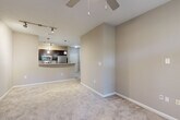 This one-bedroom, one-bathroom unit at 2345 Peachwood Cir NE in Atlanta, GA offers a well-designed, single-floor layout that maximizes every square foot. The open-concept living and kitchen area forms the heart of the home, where warm neutral tones, plush carpet, and a ceiling fan create a comfortable and inviting atmosphere. Large windows and a glass-panel door flood the living room with natural light while offering views of surrounding greenery.

The kitchen is thoughtfully equipped with dark espresso cabinetry, granite countertops, stainless steel appliances including a refrigerator, electric range, microwave, and dishwasher, and a peninsula that opens to the living area. Track and pendant lighting add both function and style. Tile flooring runs throughout the kitchen for easy maintenance.

The bedroom is generously sized, featuring plush carpet, a ceiling fan, and a window with views of lush trees. A spacious walk-in closet with multi-tier wire shelving provides ample storage. The bathroom is finished with tile flooring, a tub-shower combination with white tile surround, a granite-topped vanity, and dark cabinetry that mirrors the kitchen's design. A hallway connects the spaces cohesively, completing this efficient and well-appointed home.