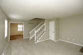 This two-floor home offers a practical and comfortable layout with consistent finishes throughout. The carpeted bedrooms are generously sized, each equipped with a ceiling fan and light fixture for comfort and air circulation. One bedroom includes a spacious closet with bifold doors, while others benefit from natural light through slatted blinds. The textured ceilings add a traditional touch to the upper level.

The kitchen is a standout feature, outfitted with crisp white cabinetry, granite-style countertops, a white tile backsplash, and hardwood-style flooring. It includes a full suite of white appliances — a refrigerator, electric range with overhead microwave, and dishwasher — along with a double-basin sink beneath a bright window.

The bathrooms are well-appointed, featuring granite vanity tops, white cabinetry, oil-rubbed bronze fixtures, and framed mirrors. One bathroom includes a glass-door shower stall, while another offers a medicine cabinet for added storage.

A dedicated utility room with hardwood-style flooring provides hookups and venting for laundry needs. The unfinished basement houses the mechanical systems, including the furnace, water heater, and ductwork, offering functional utility space. A central staircase connects the floors, rounding out this well-structured home.