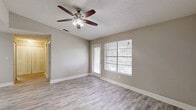 Located at 604 Laurel Lake Ct in Orlando, Florida, this one-bedroom, one-bathroom residence offers a well-organized single-floor layout with a clean, neutral aesthetic throughout. Light-toned wood-look flooring flows continuously across all living areas, complementing the soft warm-gray walls and crisp white baseboards for a cohesive, modern feel.

The open-concept living, dining, and kitchen area forms the heart of the home. The kitchen is well-appointed with rich wood cabinetry, granite-look countertops, stainless steel appliances including a range and refrigerator, and a built-in dishwasher. A peninsula counter provides additional prep space and a natural division between the kitchen and the living and dining areas. Ceiling fans with integrated lighting fixtures are present in the main living area, enhancing comfort and airflow.

The living room receives generous natural light through large windows with blinds and provides direct access to the balcony, extending the living space outdoors. The bedroom is a comfortable size, featuring its own window for natural light, a ceiling fan, and access to a walk-in closet. The full bathroom includes a warm wood-toned vanity with a granite-look countertop, a large mirror, and modern light fixtures. Additional conveniences include a dedicated laundry area, a utility room, and ample closet storage throughout.