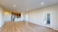 Located at 4550 Falmer Dr in Bethlehem, PA, this well-designed 2-bedroom, 2-bathroom single-floor home offers a thoughtfully planned layout that balances comfort and functionality. Light-toned hardwood-style flooring runs throughout, complementing the neutral, warm color palette that unifies every room.

The open-concept living area is bright and welcoming, with recessed lighting and large windows that invite abundant natural light. A door leads to an outdoor balcony, extending the living space further. The kitchen is a standout feature, equipped with rich dark-toned cabinetry, stainless steel appliances including a refrigerator, range, and microwave, white quartz countertops, a stainless steel sink, and an island with elegant pendant lighting overhead — ideal for both meal prep and casual dining.

A hallway connects the two bedrooms, each fitted with ceiling fans and generous windows offering outdoor views. The spacious primary bedroom provides a well-sized retreat with its own closet. Both bathrooms are clean and functional, with one featuring a full tub-shower combination with brushed nickel fixtures. Each bedroom is served by a dedicated closet, enhancing storage throughout the home. This move-in-ready residence offers a modern, low-maintenance lifestyle in a contemporary setting.