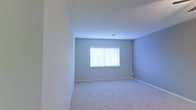 Located at 4881 Kingshill Dr in Columbus, Ohio, this single-floor home offers a straightforward and functional layout designed for comfortable everyday living. The interior features soft, neutral wall tones in a calming gray-blue palette, creating a clean and versatile backdrop suitable for a variety of furnishing styles. Plush wall-to-wall carpeting runs throughout the living areas, adding warmth underfoot and contributing to a quiet, cozy atmosphere. The textured ceiling adds a subtle decorative element while complementing the understated aesthetic of the space. Natural light enters through blinds-equipped windows, keeping the interior bright and airy. The white baseboards and trim provide a crisp contrast against the soft wall colors, lending a tidy, well-maintained appearance throughout. The overall ambiance is calm and neutral, making the home a blank canvas ready for personalization. Situated in Columbus, OH 43229, the property benefits from its established neighborhood setting, offering accessibility to local amenities while maintaining a residential feel.