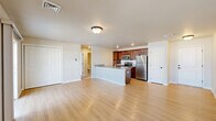 Located at 211 Sacandaga Road in Schenectady, NY, this single-floor, one-bedroom, one-bathroom residence offers a thoughtfully designed layout that maximizes both function and comfort. The open-concept living and kitchen area forms the heart of the home, where light hardwood-style flooring flows throughout, creating a bright and cohesive atmosphere. A sliding glass door in the living room invites natural light and provides access to an outdoor area, further enhancing the sense of openness.

The kitchen is a standout feature, showcasing rich dark cabinetry, granite countertops, a breakfast bar peninsula with an integrated sink, and a full suite of stainless steel appliances including a refrigerator, range, and built-in microwave. Ample cabinet storage and generous counter space make this kitchen as practical as it is attractive.

The bedroom is a comfortable retreat, carpeted for warmth and equipped with two windows that allow natural light to filter in. A closet door and direct hallway access add convenience to the space.

The bathroom is well-finished with a granite-topped vanity, rich wood cabinetry, a full tub/shower combination, and neutral tile flooring. Additional spaces include hallways and a utility room, rounding out the efficient and practical floor plan of this move-in-ready residence.