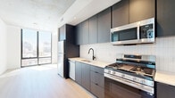 Located at 625 N 2nd Ave in the heart of downtown Phoenix, this contemporary 2-bedroom, 2-bathroom residence showcases a clean, modern aesthetic throughout. Light-toned hardwood-style flooring flows seamlessly across the open-concept living, dining, and kitchen area, complemented by exposed concrete ceilings that add an industrial-chic character to the space. The kitchen is thoughtfully designed with dark, flat-front cabinetry reaching to the ceiling, white subway tile backsplash, light quartz countertops, stainless steel appliances including a gas range, built-in microwave, refrigerator, and dishwasher, and a matte black faucet. Floor-to-ceiling windows bathe the living area and bedrooms in natural light while offering open city views of the Phoenix skyline. The spacious primary bedroom benefits from corner windows on two walls, maximizing both light and views. Both bathrooms feature large-format tile flooring, walk-in glass showers with white tile surround, matte black fixtures, and floating vanities. Three closets and an in-unit laundry area provide practical storage throughout. The overall ambiance is sleek, bright, and urban — ideal for modern city living.